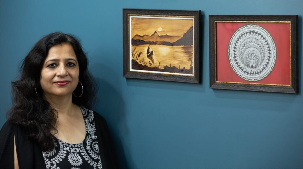 Vandana Bhasin standing beside a wall in her studio